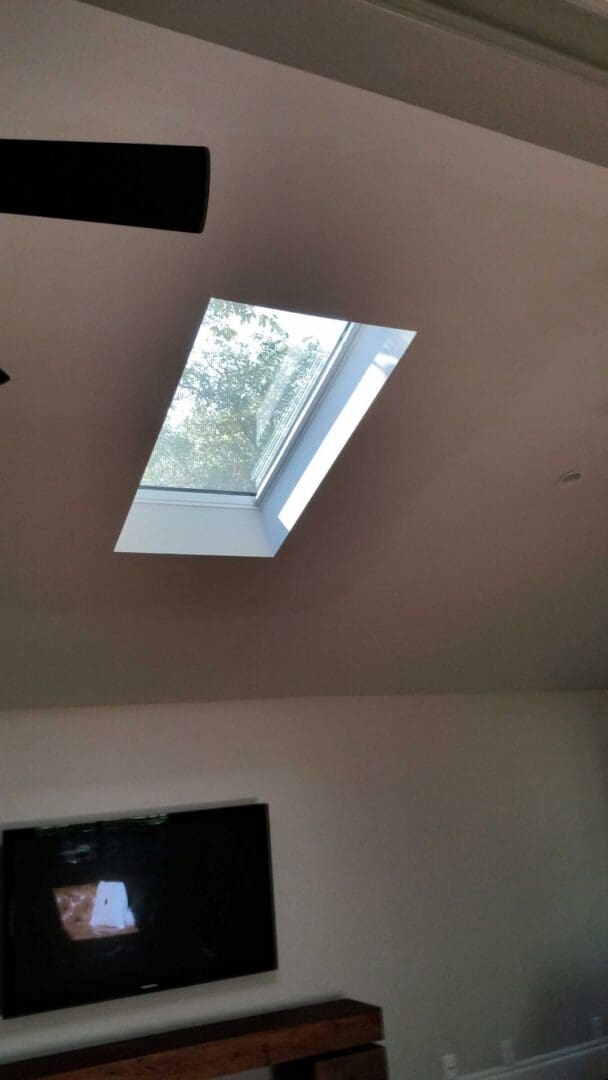 A skylight in the ceiling of a room.