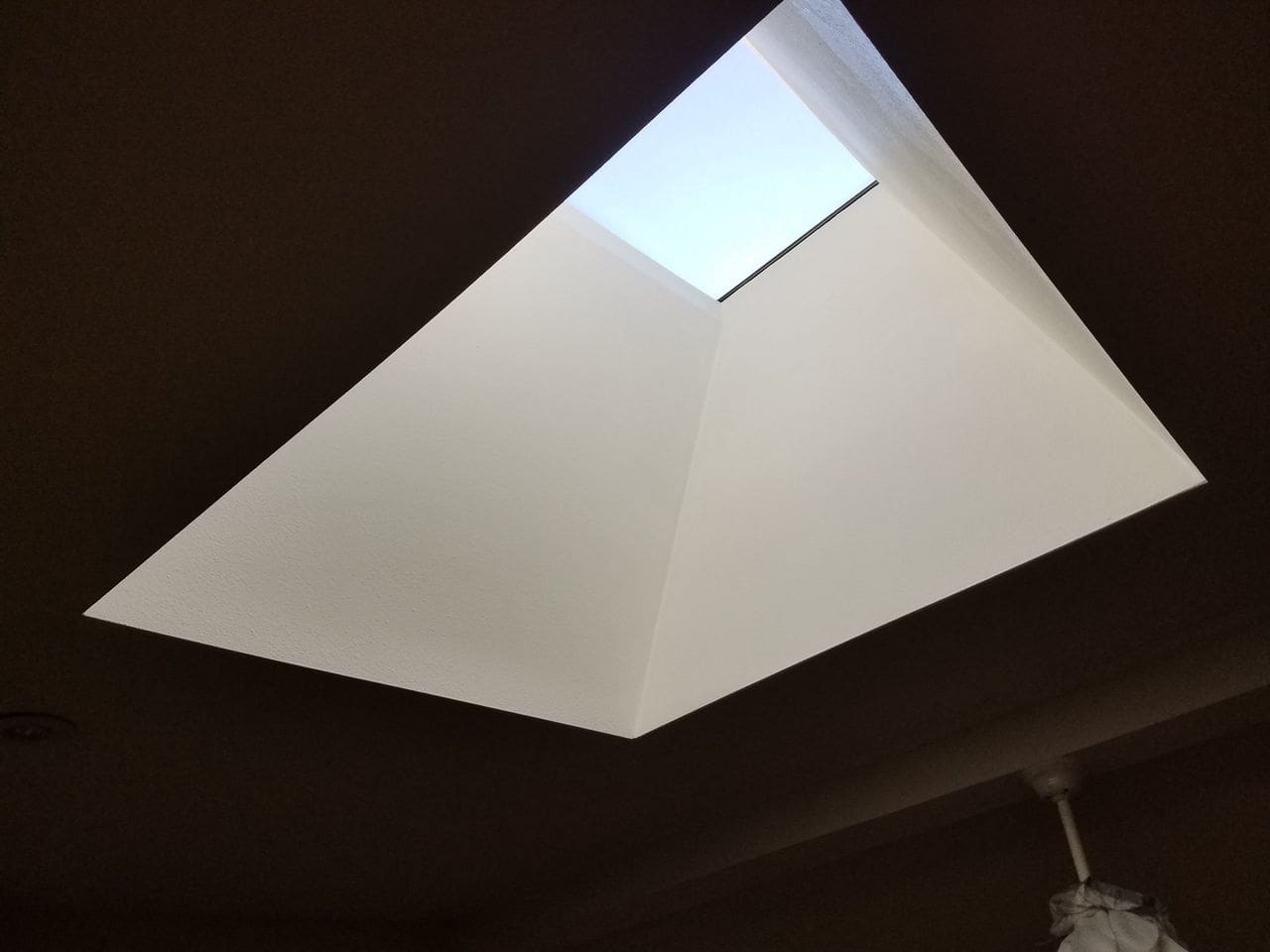 A skylight in the ceiling of an open room.