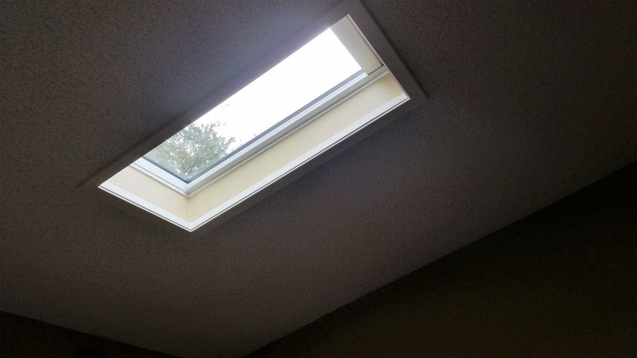 A skylight in the ceiling of an open room.