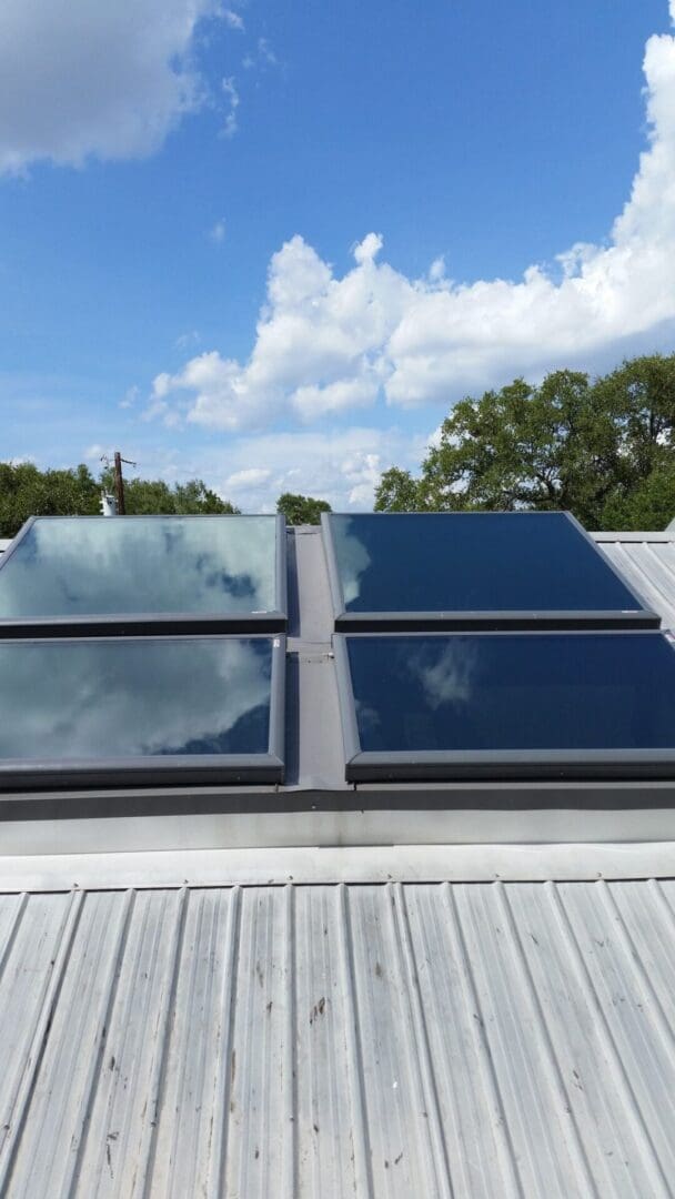 A close up of four solar panels on the roof