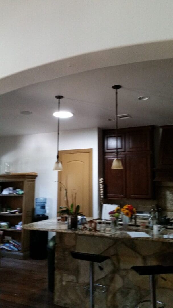 A kitchen with two lights and a counter