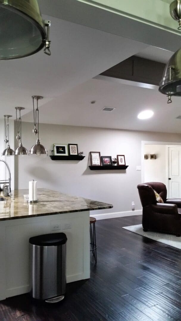 A kitchen with a bar and chairs in it