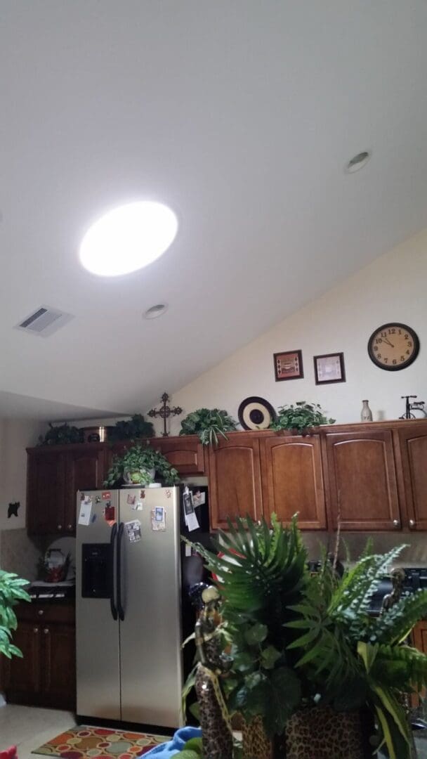 A kitchen with cabinets and refrigerator in it