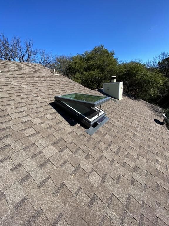 A roof with a chimney and a vent on it