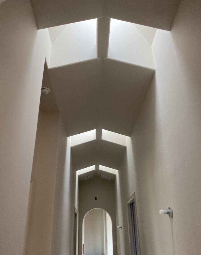 A hallway with many windows and a light